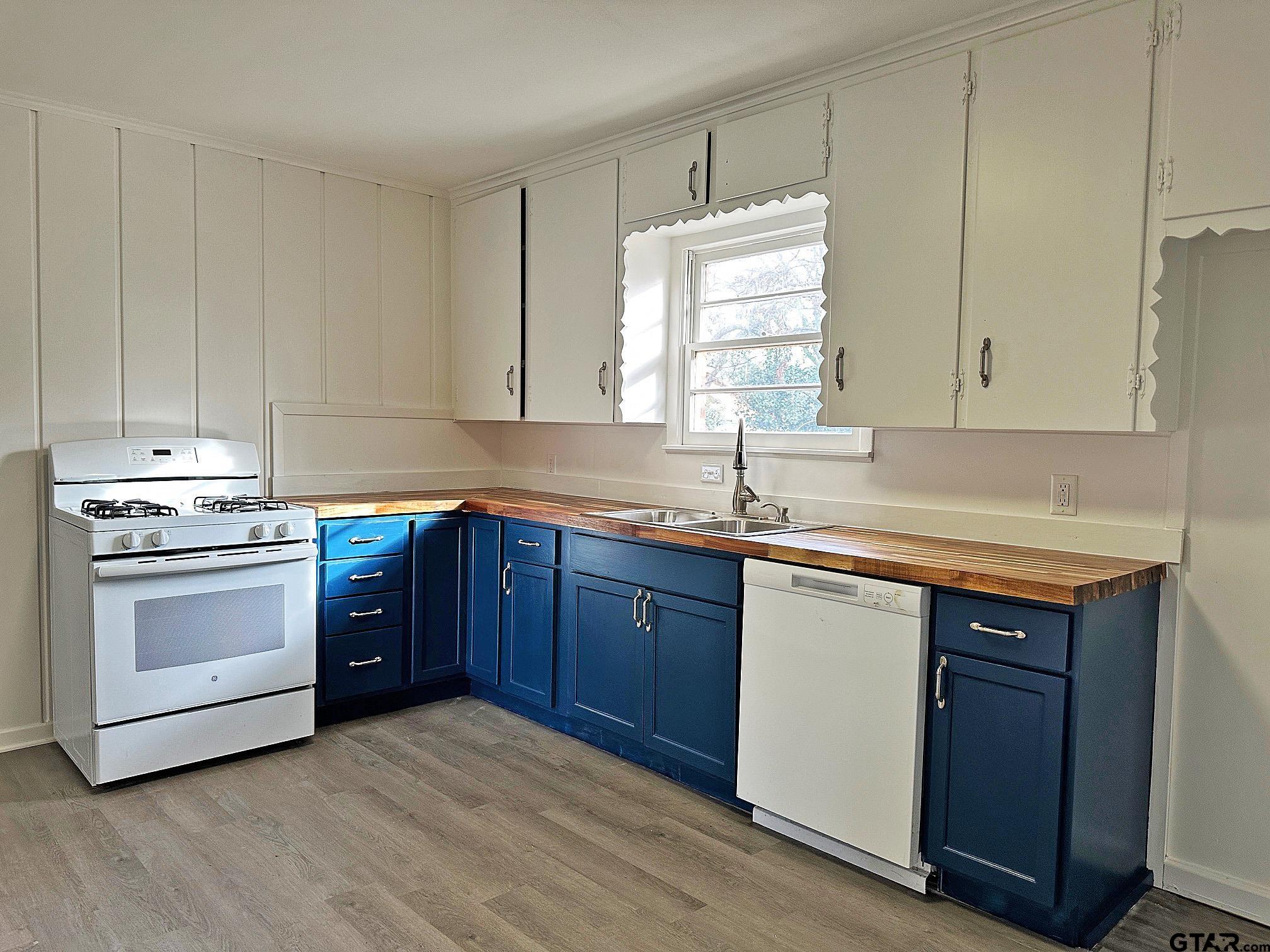 2331 Lingner Drive Tyler, TX 75701 - Photo 6 of 17 a kitchen with stainless steel appliances granite countertop a sink stove and cabinets
