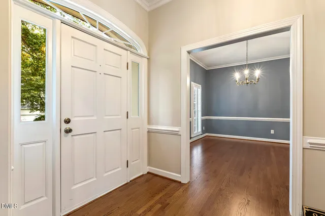 a living room with a fireplace and wooden floor