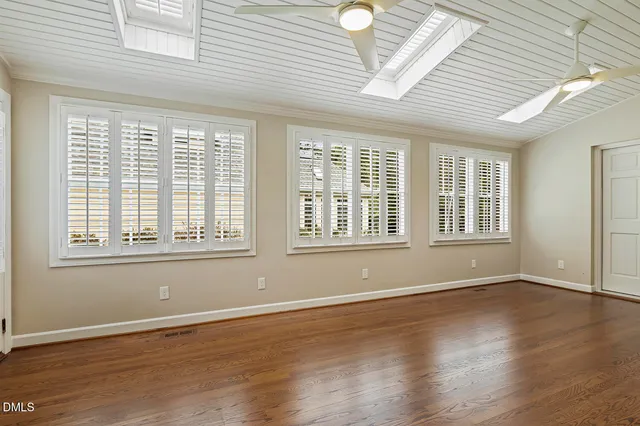 a kitchen with cabinets stainless steel appliances a sink and a window