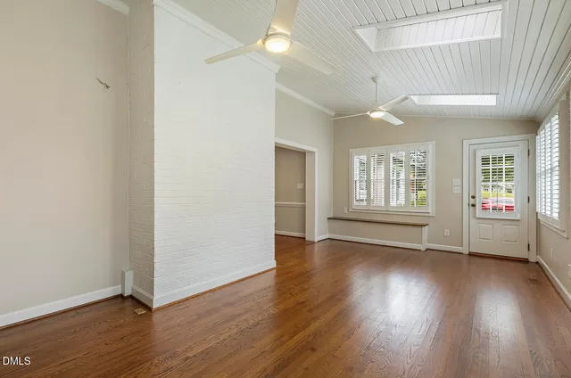 a kitchen with a white cabinets and wooden floor