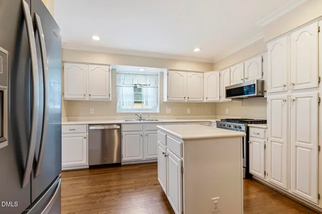 a kitchen with stainless steel appliances a refrigerator and a stove
