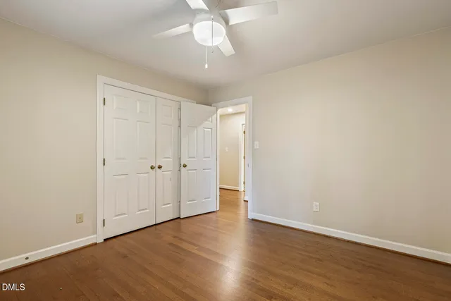 a front view of a house with a garden and yard