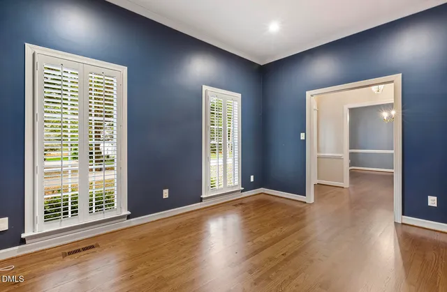a view of a room with wooden floor and chandelier