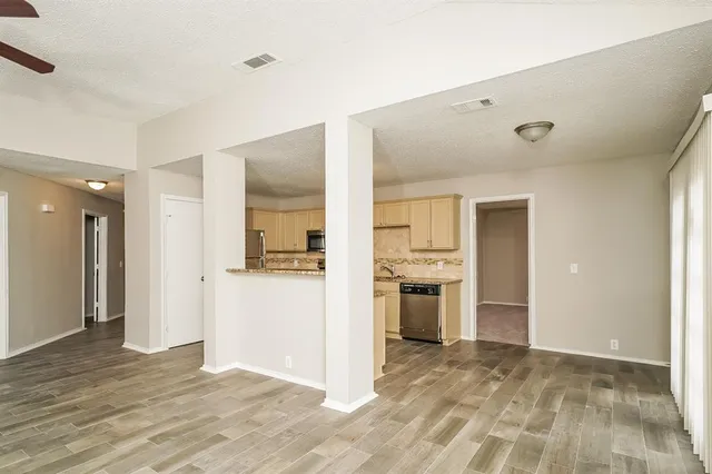 a view of a kitchen with a sink and a stove top oven