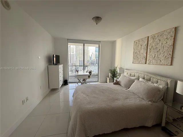 a bedroom with a bed and glass windows