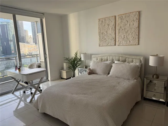 a bedroom with a bed and a table in it