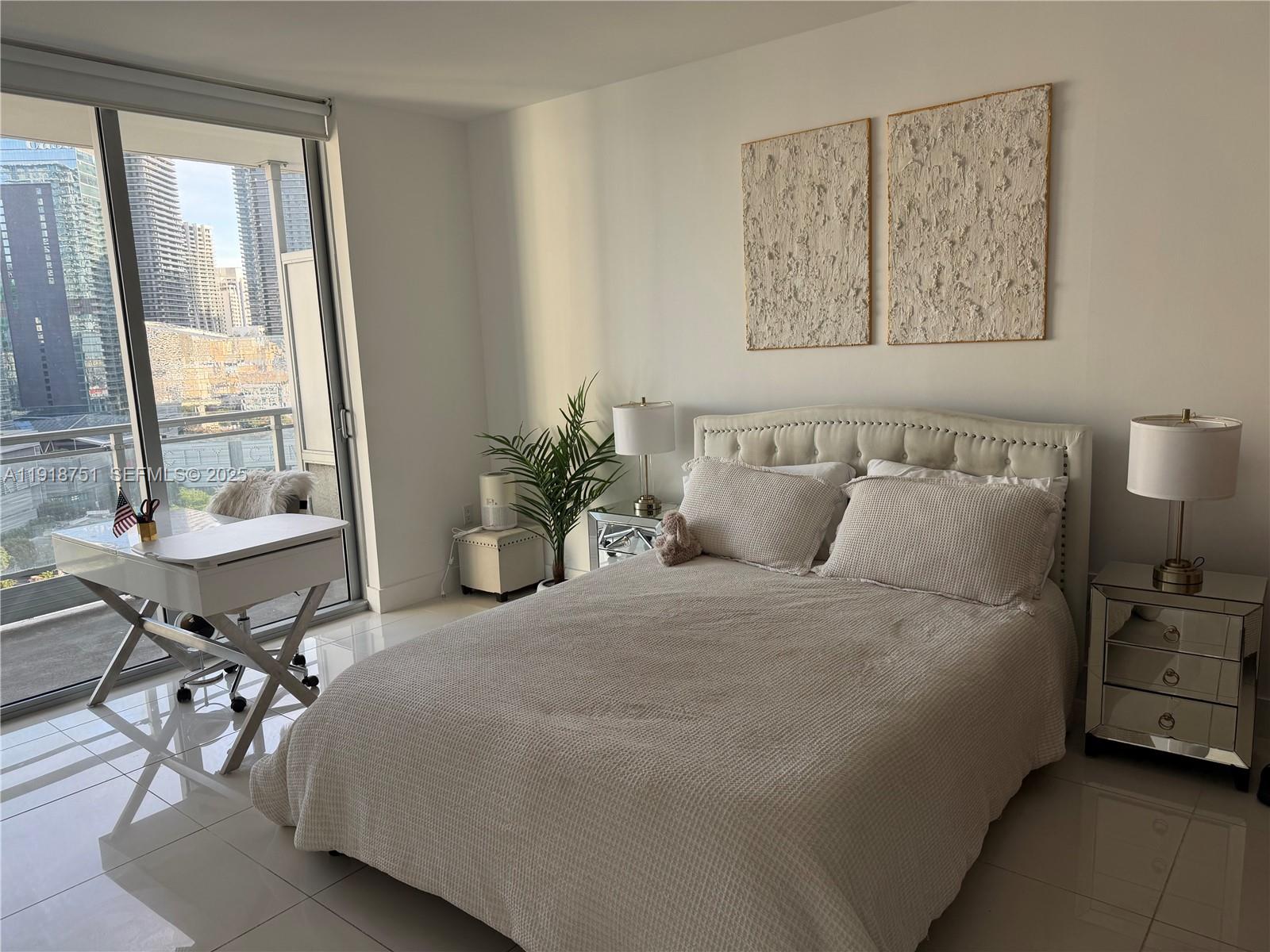 90 Southwest 3rd Street, Unit 2202 Miami, FL 33130 - Photo 13 of 33 a bedroom with a bed and a table in it