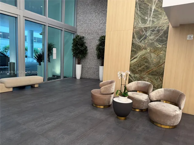 a living room with furniture and a potted plant