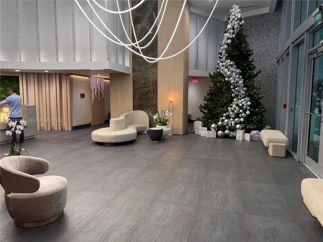 a living room with furniture and flowers