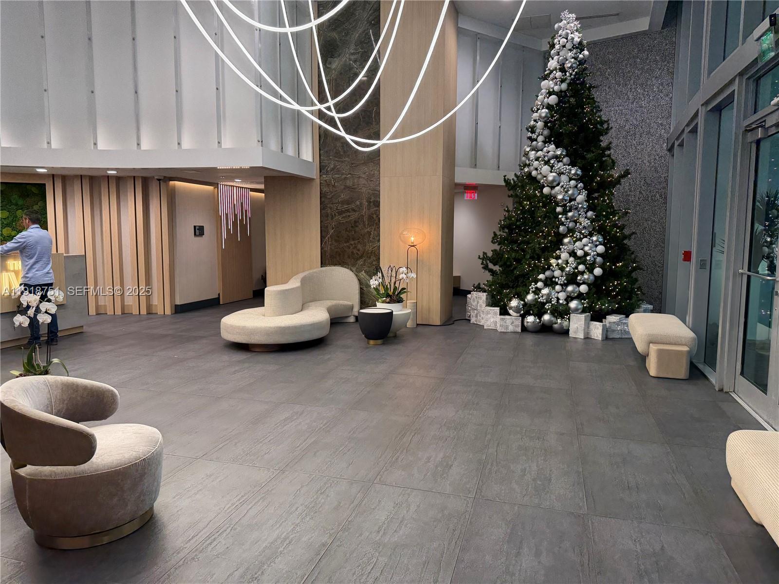 90 Southwest 3rd Street, Unit 2202 Miami, FL 33130 - Photo 20 of 33 a living room with furniture and flowers