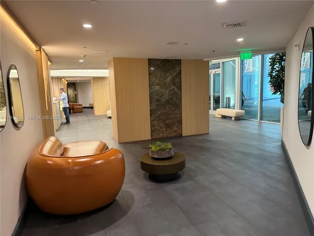 a living room with furniture and gym equipment