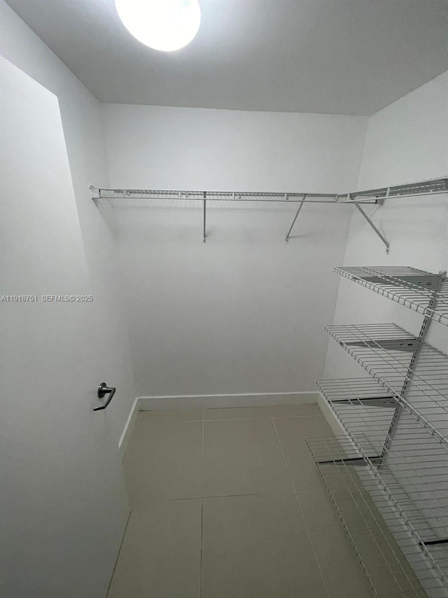 90 Southwest 3rd Street, Unit 2202 Miami, FL 33130 - Photo 30 of 33 a view of a room with racks on the wall