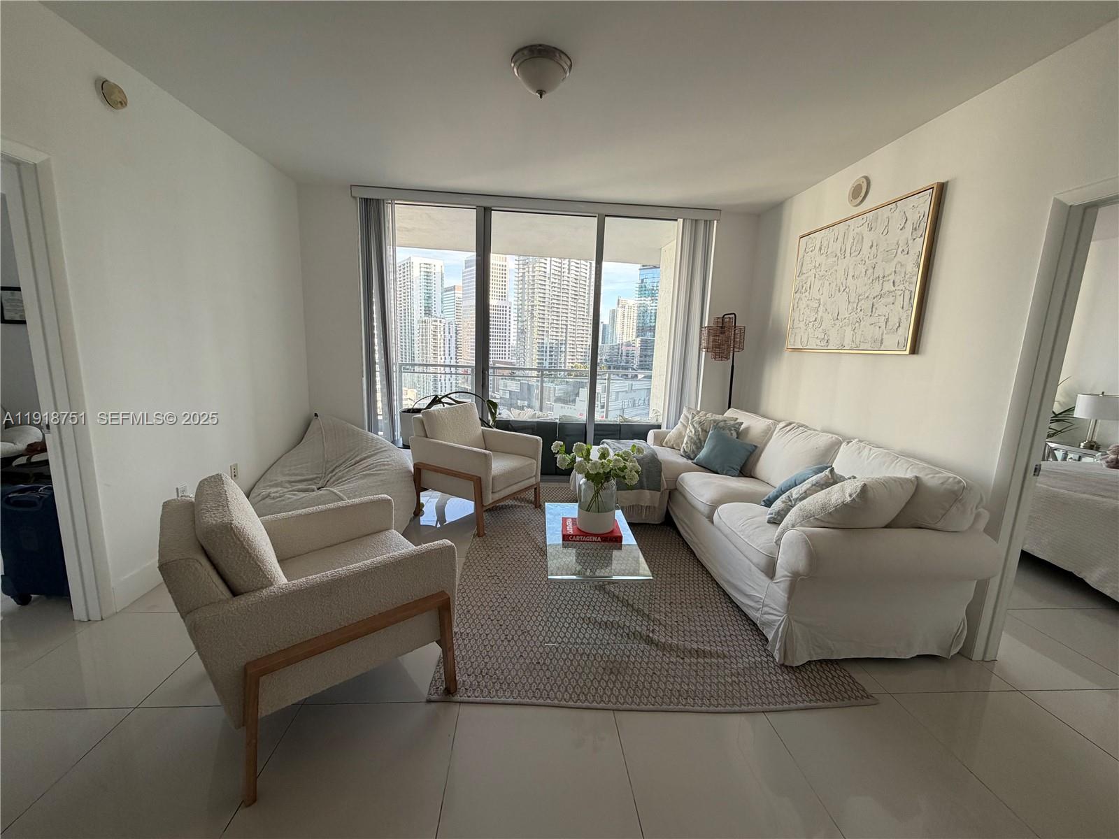 90 Southwest 3rd Street, Unit 2202 Miami, FL 33130 - Photo 5 of 33 a living room with furniture and a large window