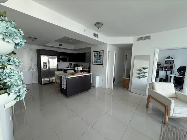 a living room with furniture and flowers