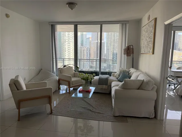a living room with furniture and large windows