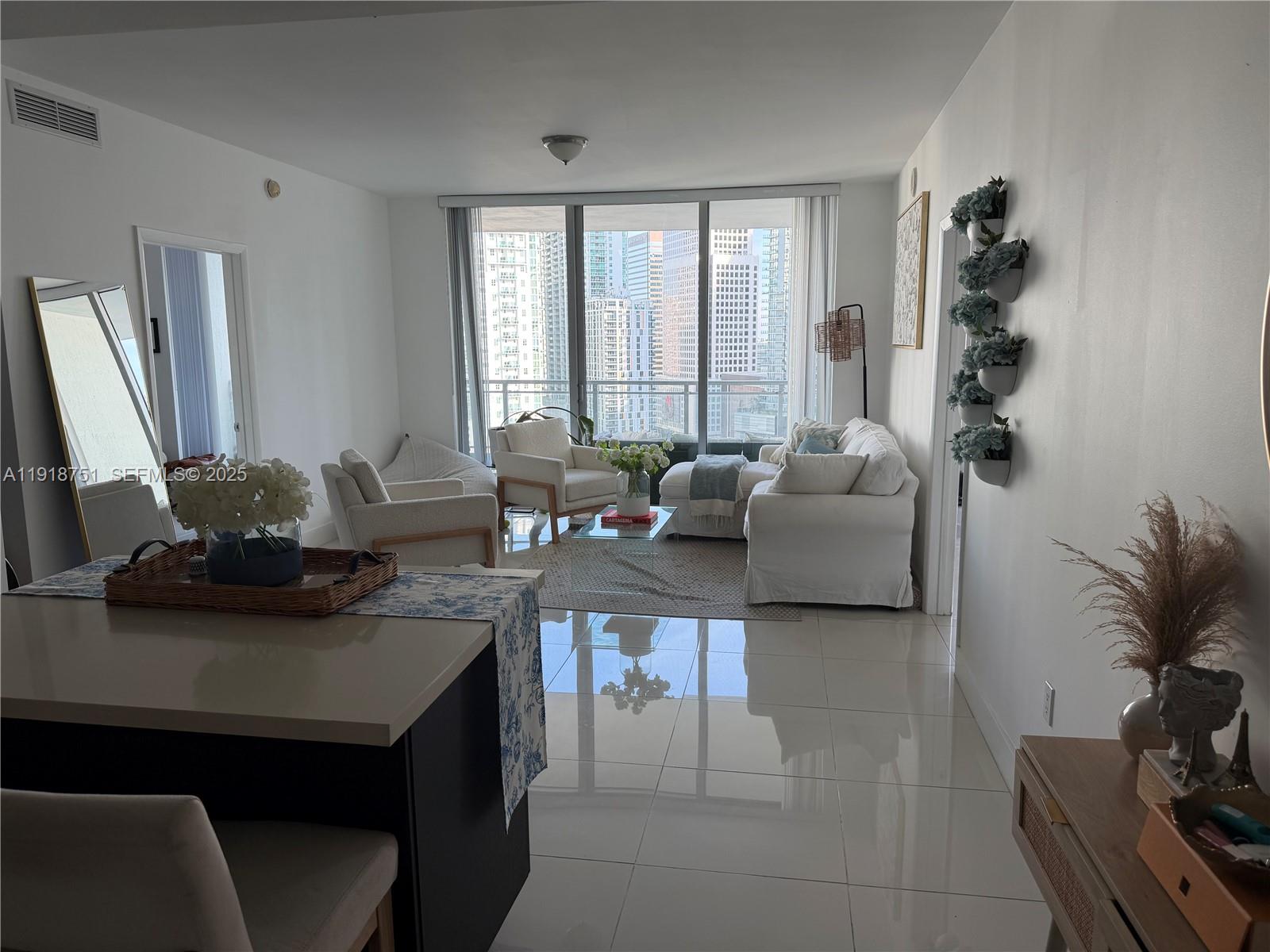 90 Southwest 3rd Street, Unit 2202 Miami, FL 33130 - Photo 8 of 33 a living room with furniture and large windows