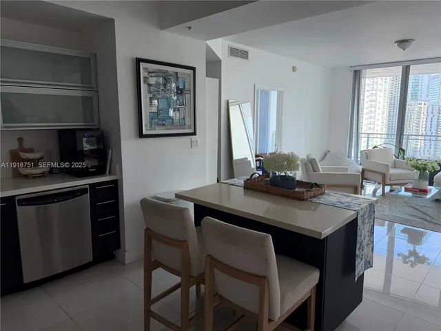 a kitchen with a table chairs a stove and a window