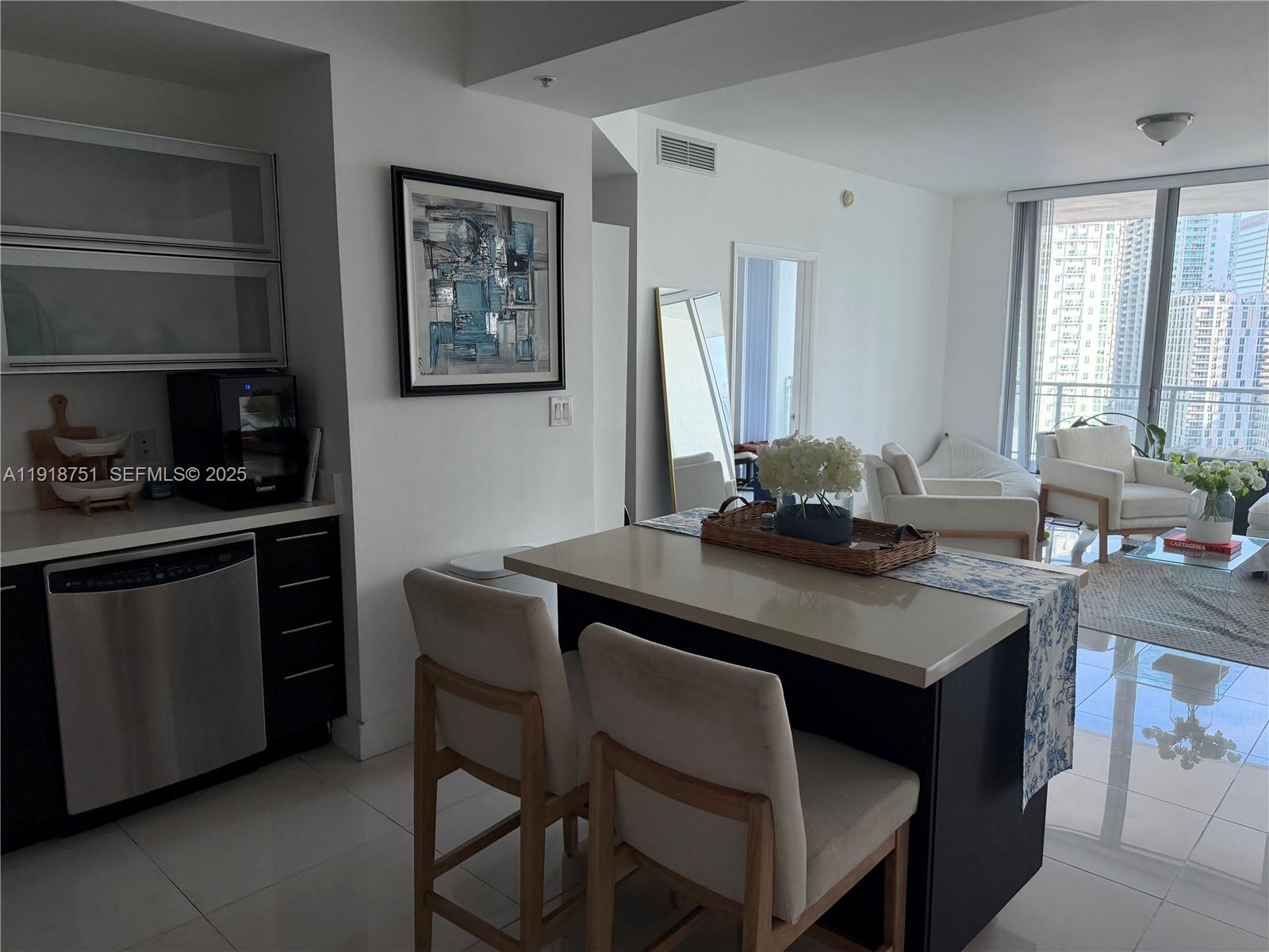90 Southwest 3rd Street, Unit 2202 Miami, FL 33130 - Photo 9 of 33 a kitchen with a table chairs a stove and a window