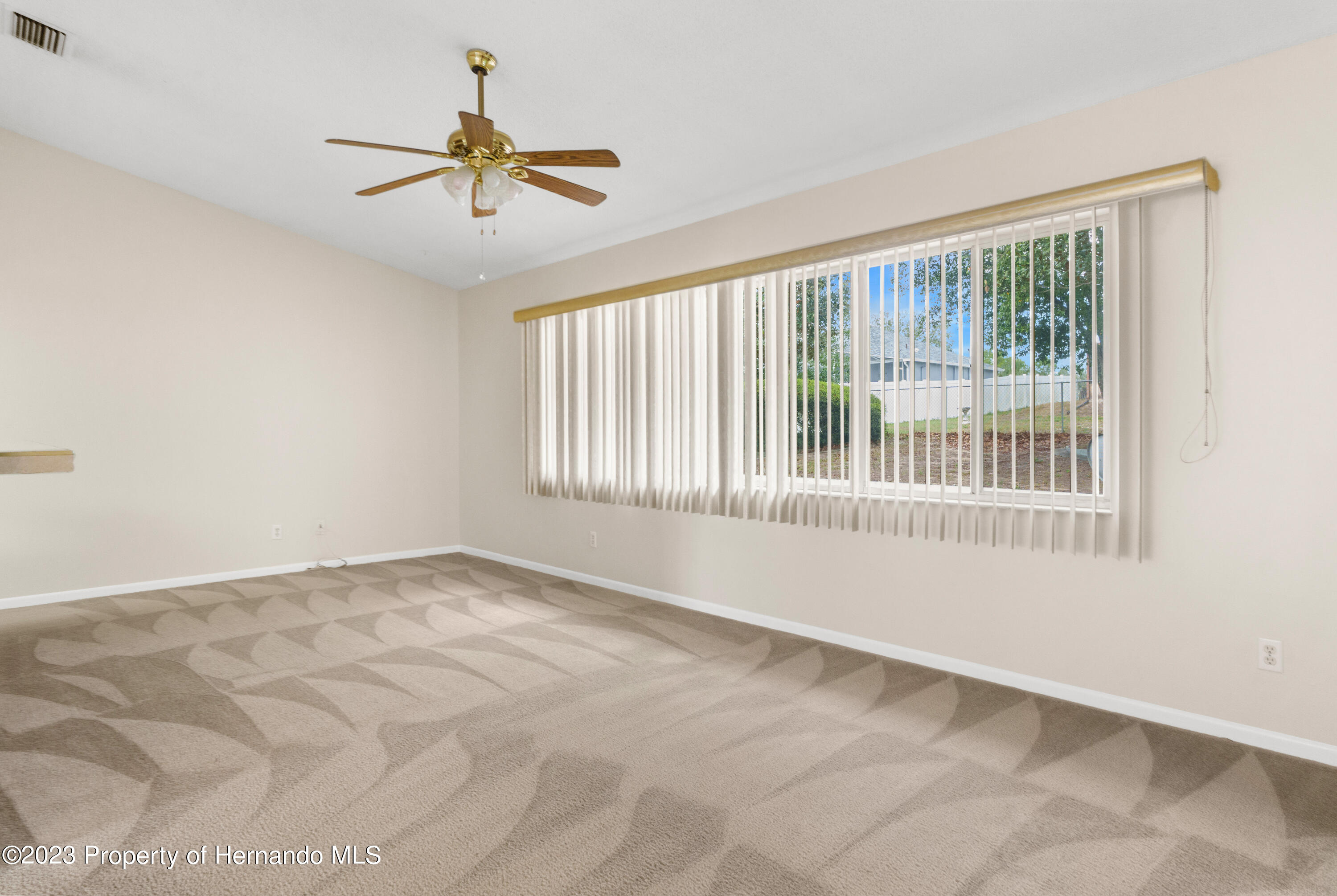 10241 Bedford Road Spring Hill, FL 34608 - Photo 5 of 32 a view of an empty room with a window