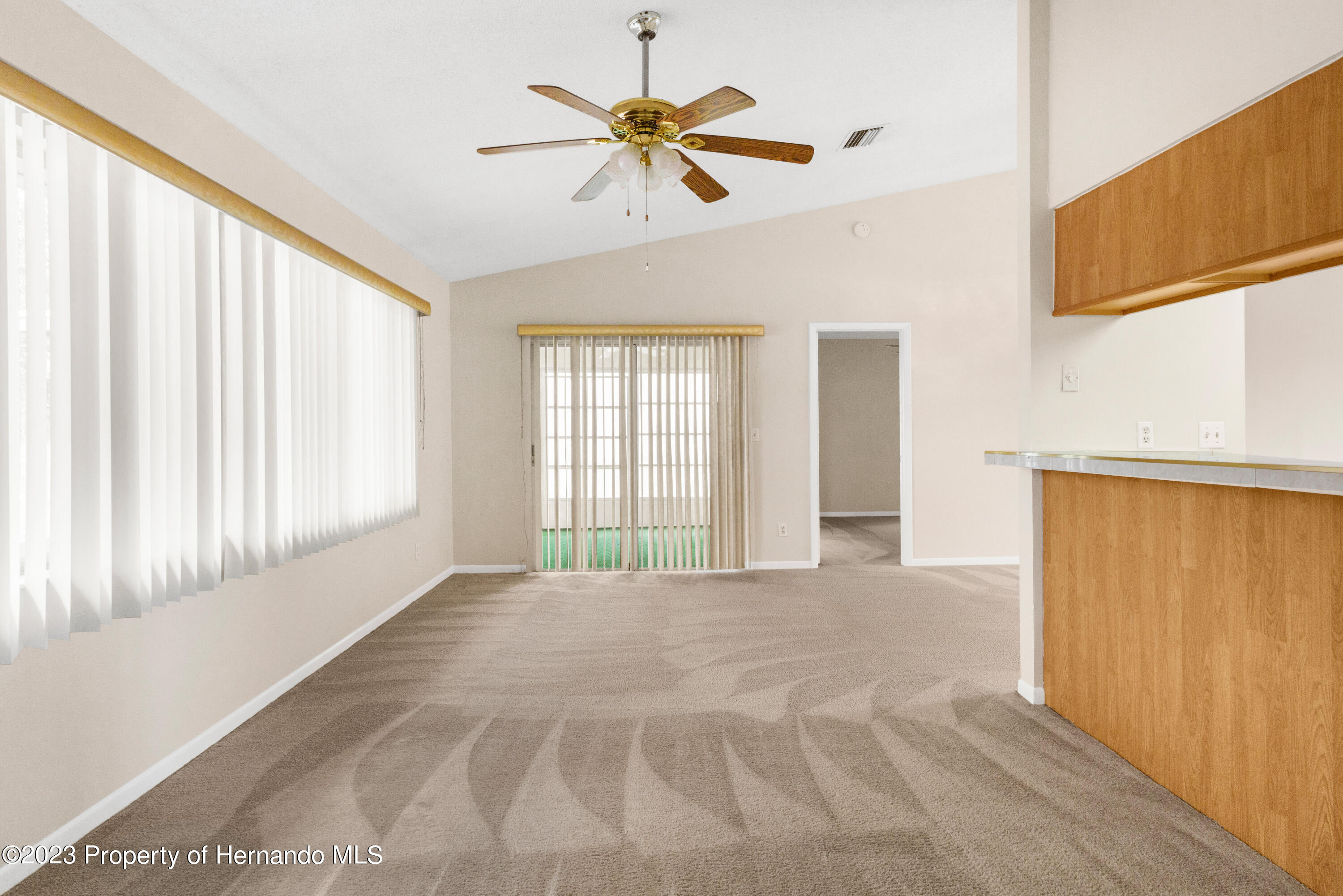 10241 Bedford Road Spring Hill, FL 34608 - Photo 6 of 32 a view of an empty room with a window