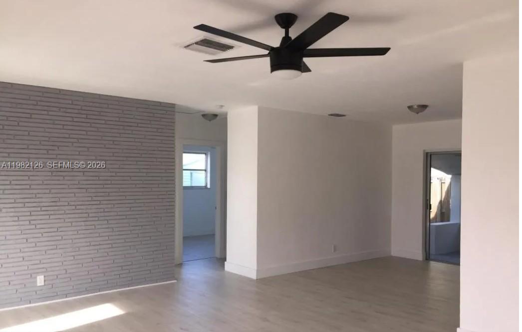 320 Southwest 7th Court Hallandale Beach, FL 33009 - Photo 2 of 5 a view of a livingroom with a ceiling fan and wooden floor
