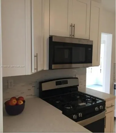 a kitchen with a stove and a microwave