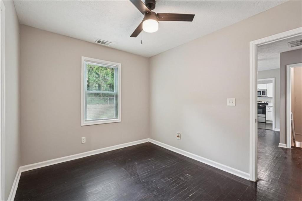 172 Meador Way Southeast Atlanta, GA 30315 - Photo 13 of 34 an empty room with wooden floor closet and windows