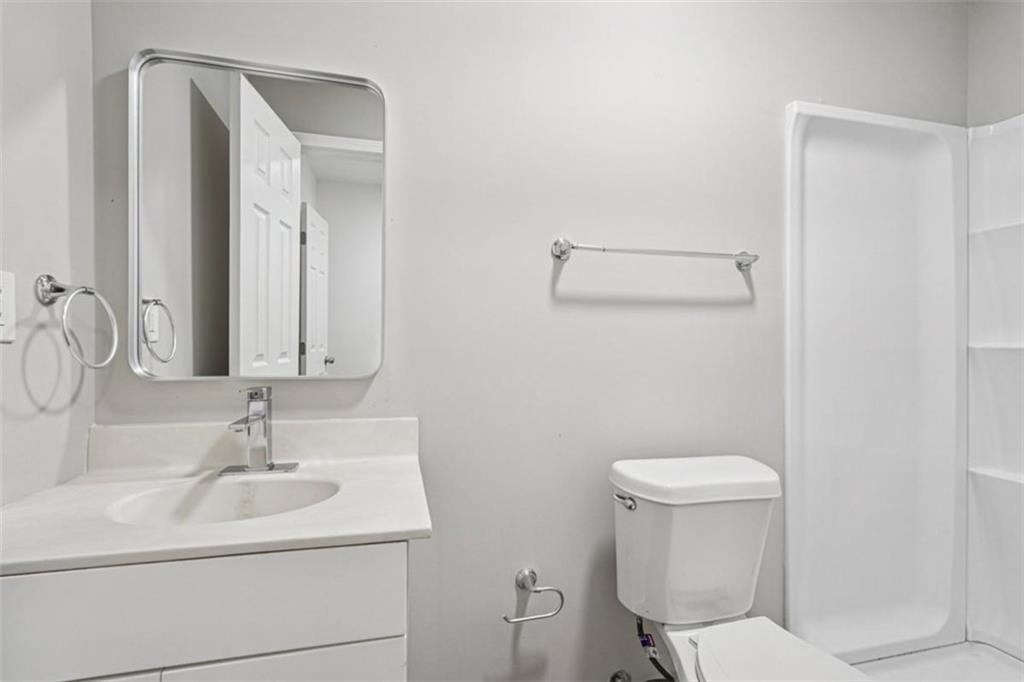 172 Meador Way Southeast Atlanta, GA 30315 - Photo 15 of 34 a bathroom with a sink a toilet and mirror