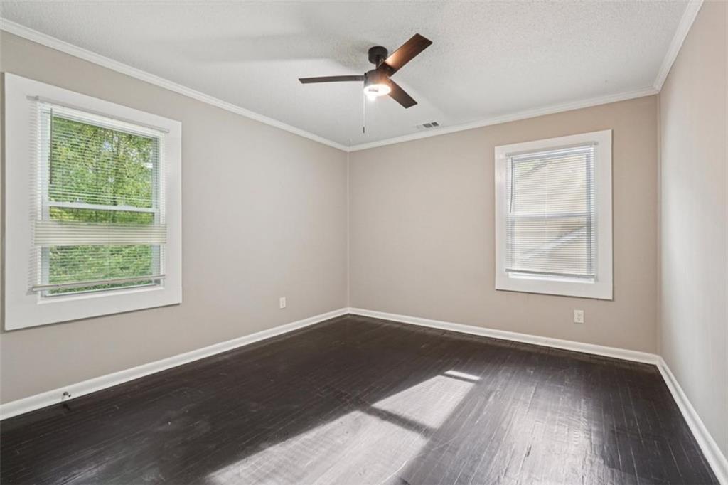 172 Meador Way Southeast Atlanta, GA 30315 - Photo 17 of 34 a view of an empty room with wooden floor and a window