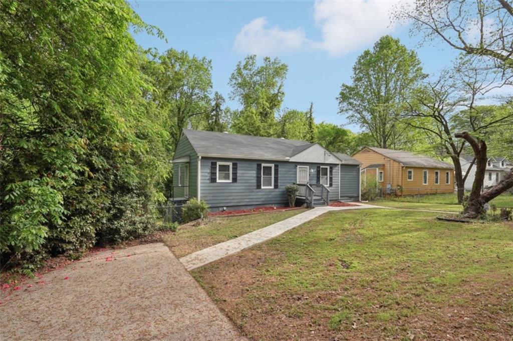 172 Meador Way Southeast Atlanta, GA 30315 - Photo 2 of 34 a front view of a house with yard tree and wooden fence