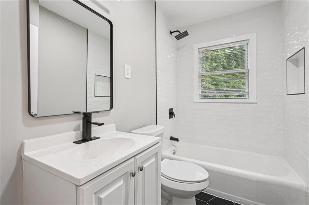 172 Meador Way Southeast Atlanta, GA 30315 - Photo 21 of 34 a bathroom with a sink toilet vanity and tub