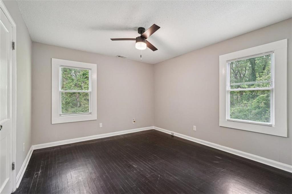 172 Meador Way Southeast Atlanta, GA 30315 - Photo 24 of 34 a view of an empty room with wooden floor and a window
