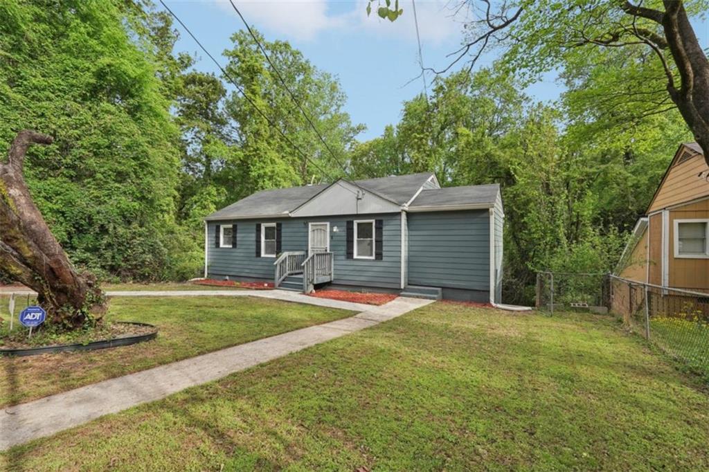 172 Meador Way Southeast Atlanta, GA 30315 - Photo 3 of 34 a front view of a house with a yard
