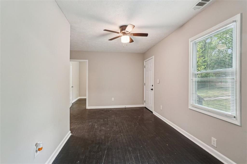 172 Meador Way Southeast Atlanta, GA 30315 - Photo 7 of 34 a view of an empty room with wooden floor and a window