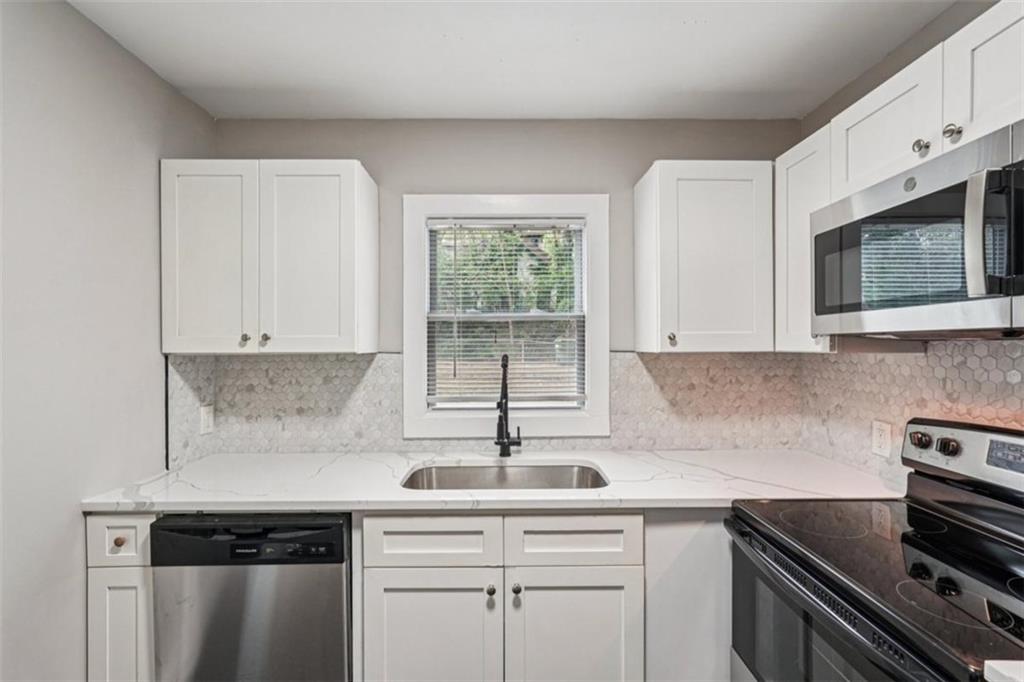 172 Meador Way Southeast Atlanta, GA 30315 - Photo 10 of 34 a kitchen with appliances cabinets and a sink