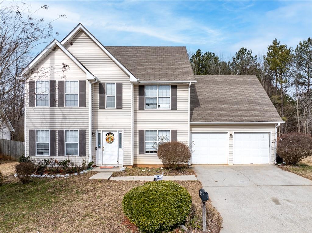 4902 Hidden Creek Place Decatur, GA 30035 - Photo 1 of 1 a front view of a house with a yard and garage