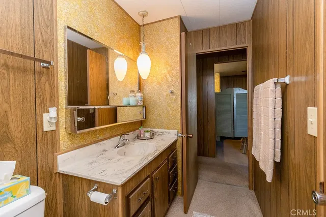 a bedroom with a bed and a night stand