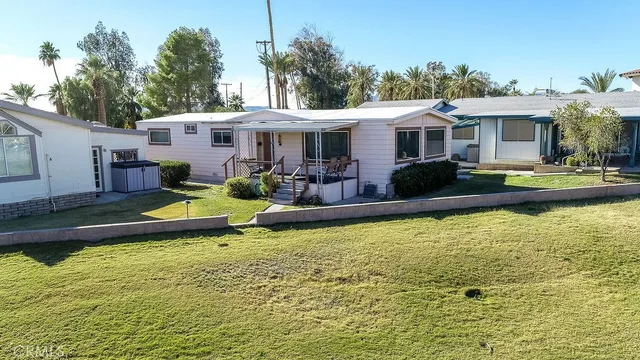 a view of a house with swimming pool and porch with furniture
