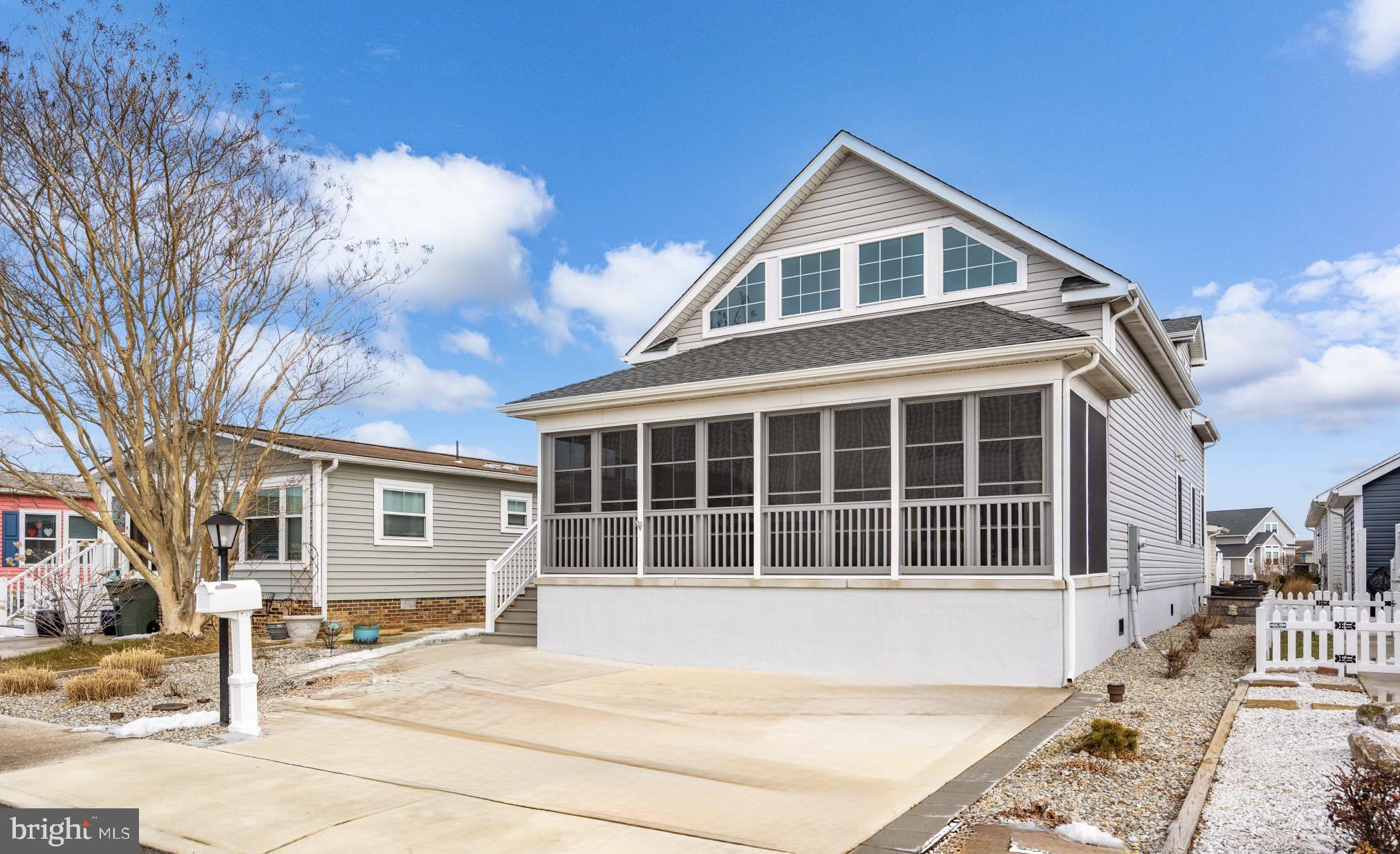 144 Clamshell Road Ocean City, MD 21842 - Photo 1 of 64 a front view of a house with a yard