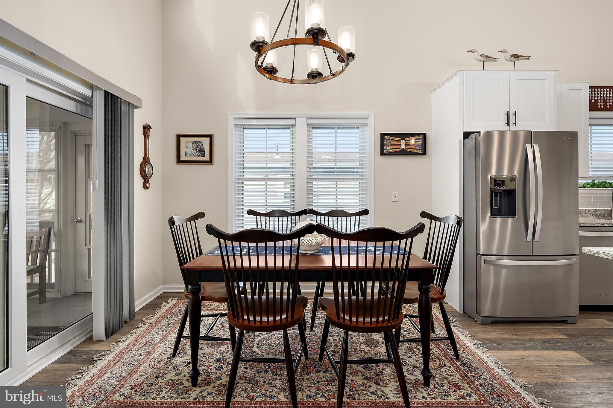 144 Clamshell Road Ocean City, MD 21842 - Photo 20 of 64 a view of a dining room with furniture window and wooden floor