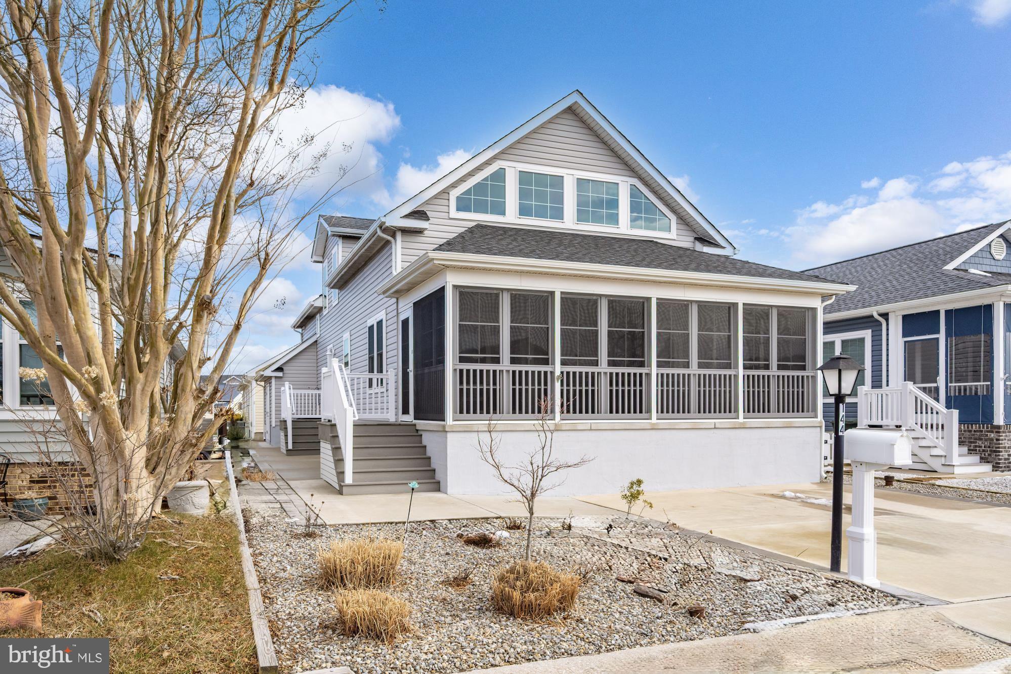 144 Clamshell Road Ocean City, MD 21842 - Photo 2 of 64 a front view of a house with a yard and seating space