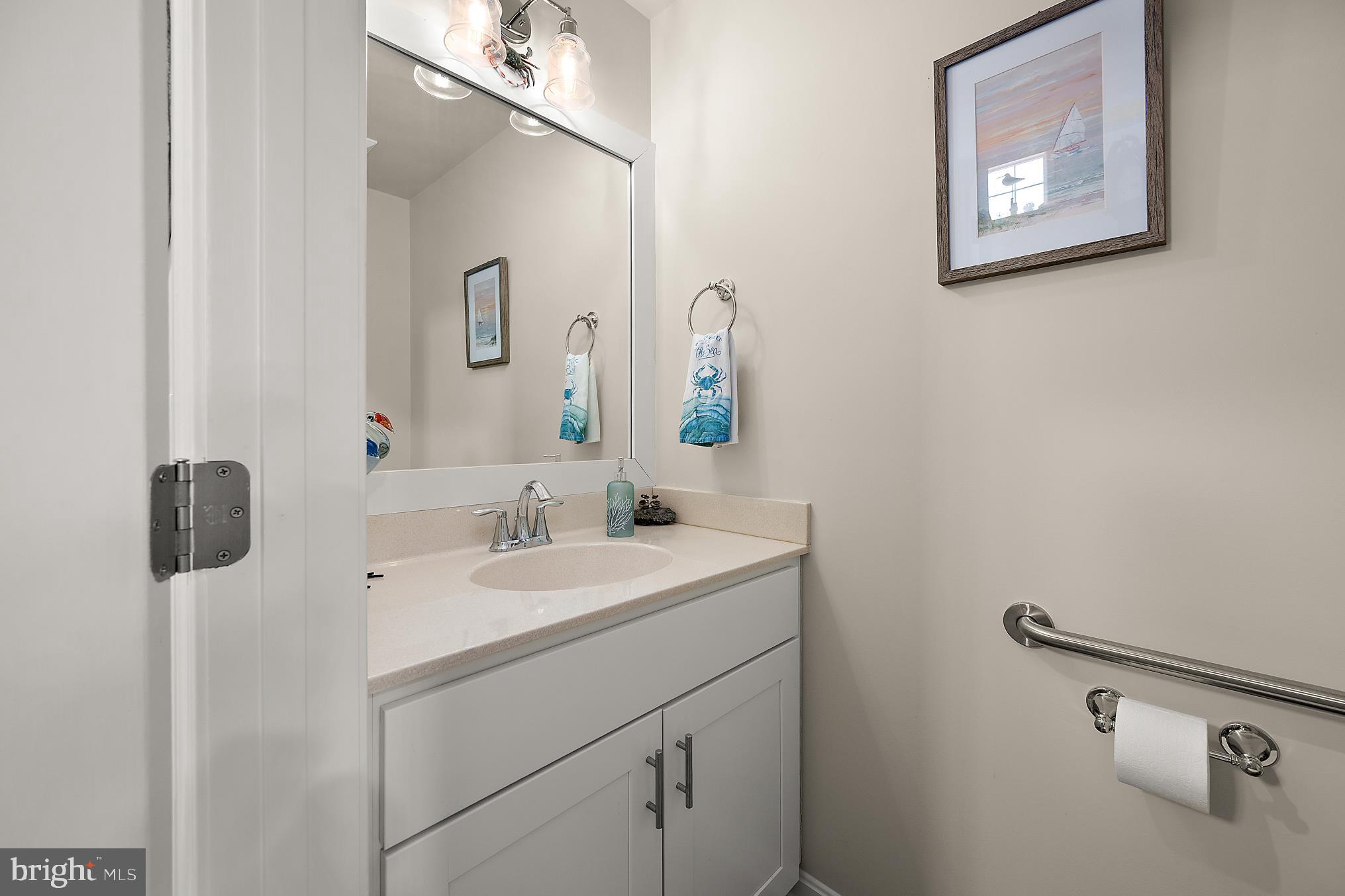 144 Clamshell Road Ocean City, MD 21842 - Photo 22 of 64 a bathroom with a sink and a mirror