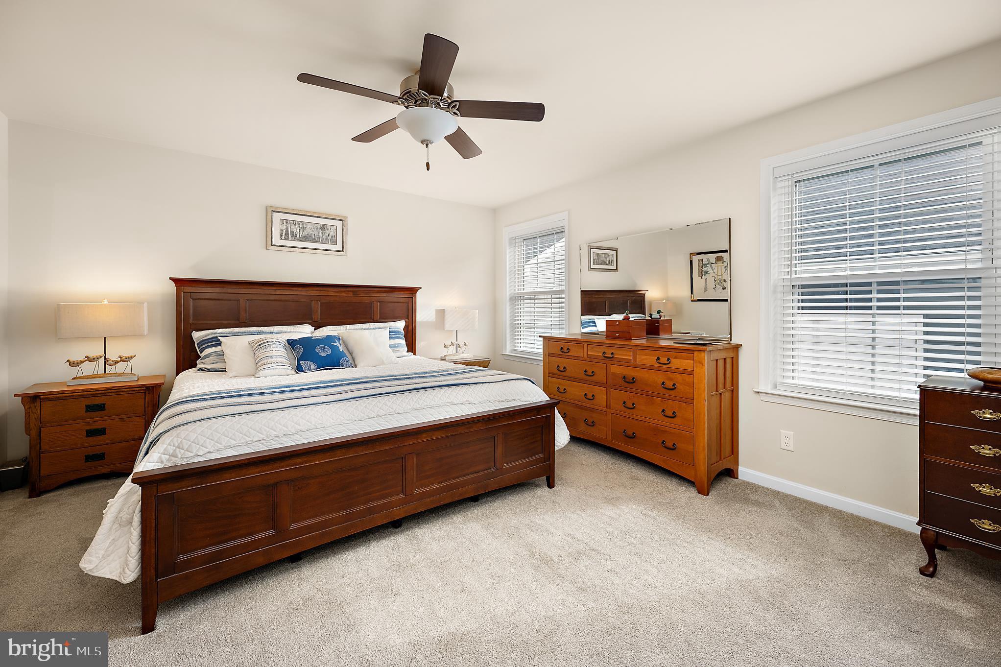 144 Clamshell Road Ocean City, MD 21842 - Photo 24 of 64 a bedroom with a bed and a ceiling fan