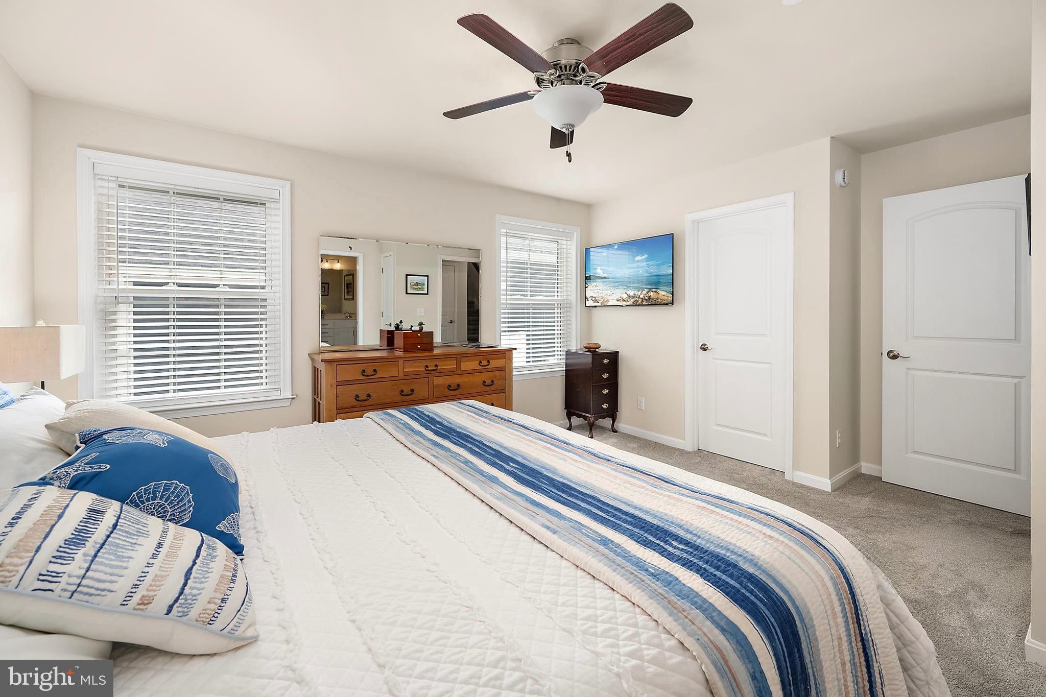 144 Clamshell Road Ocean City, MD 21842 - Photo 25 of 64 a bedroom with a large bed and a window
