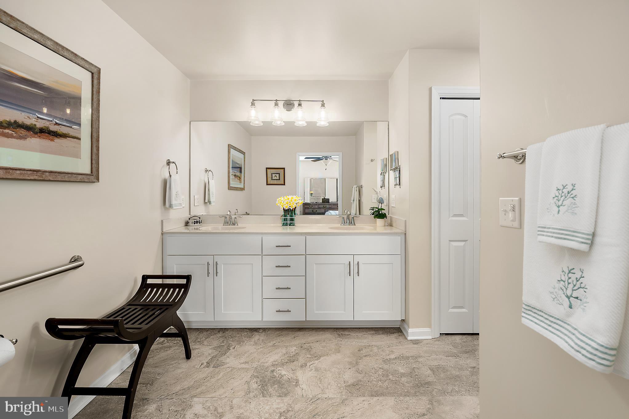 144 Clamshell Road Ocean City, MD 21842 - Photo 27 of 64 a spacious bathroom with a granite countertop sink a mirror a vanity and a shower