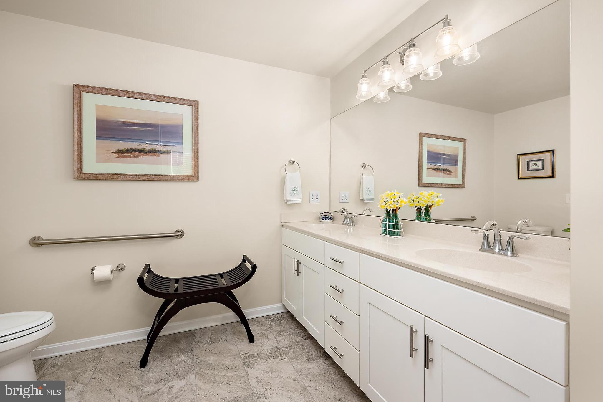 144 Clamshell Road Ocean City, MD 21842 - Photo 30 of 64 a spacious bathroom with a toilet sink and mirror