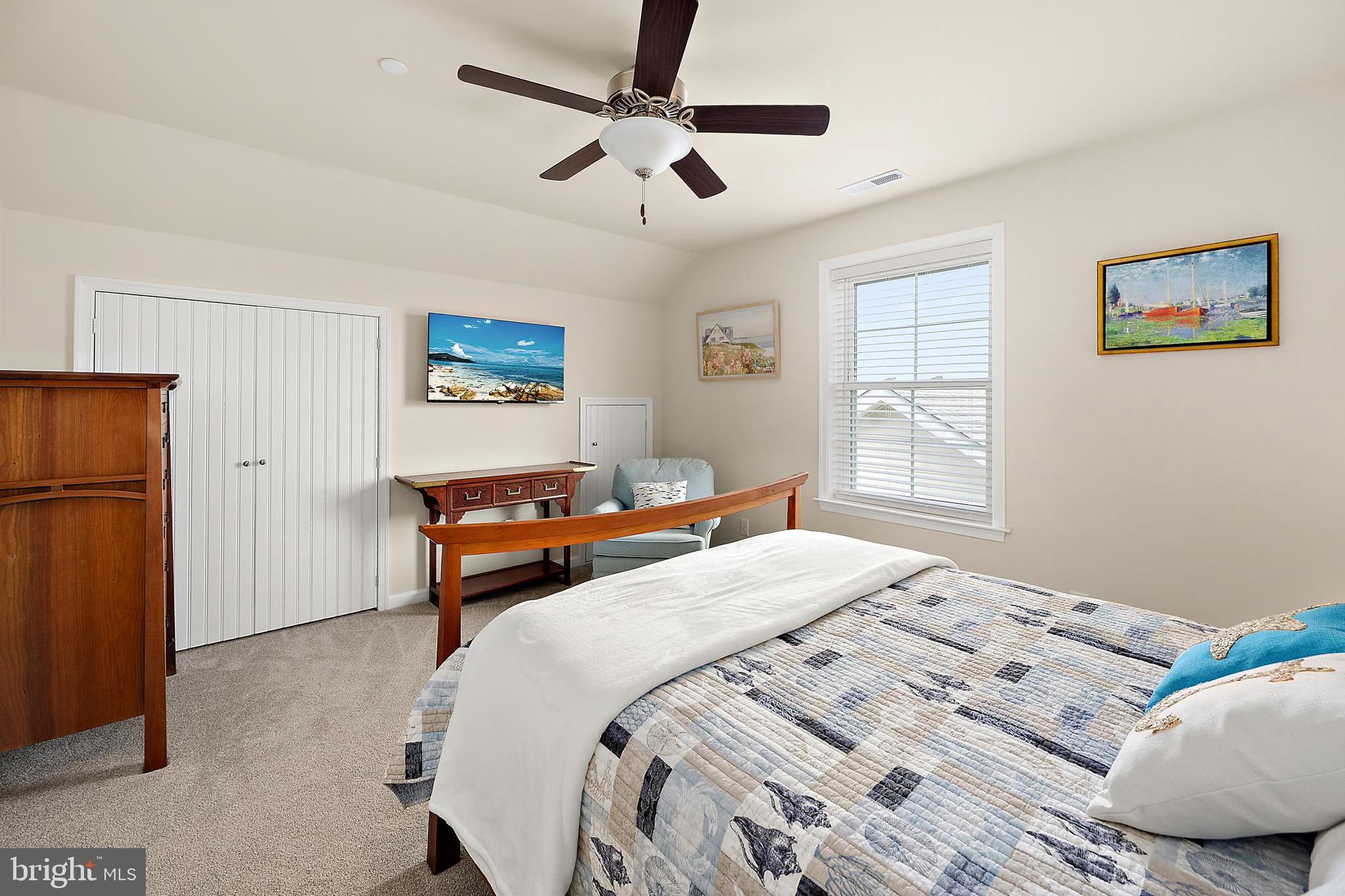 144 Clamshell Road Ocean City, MD 21842 - Photo 36 of 64 a bedroom with a bed and a window