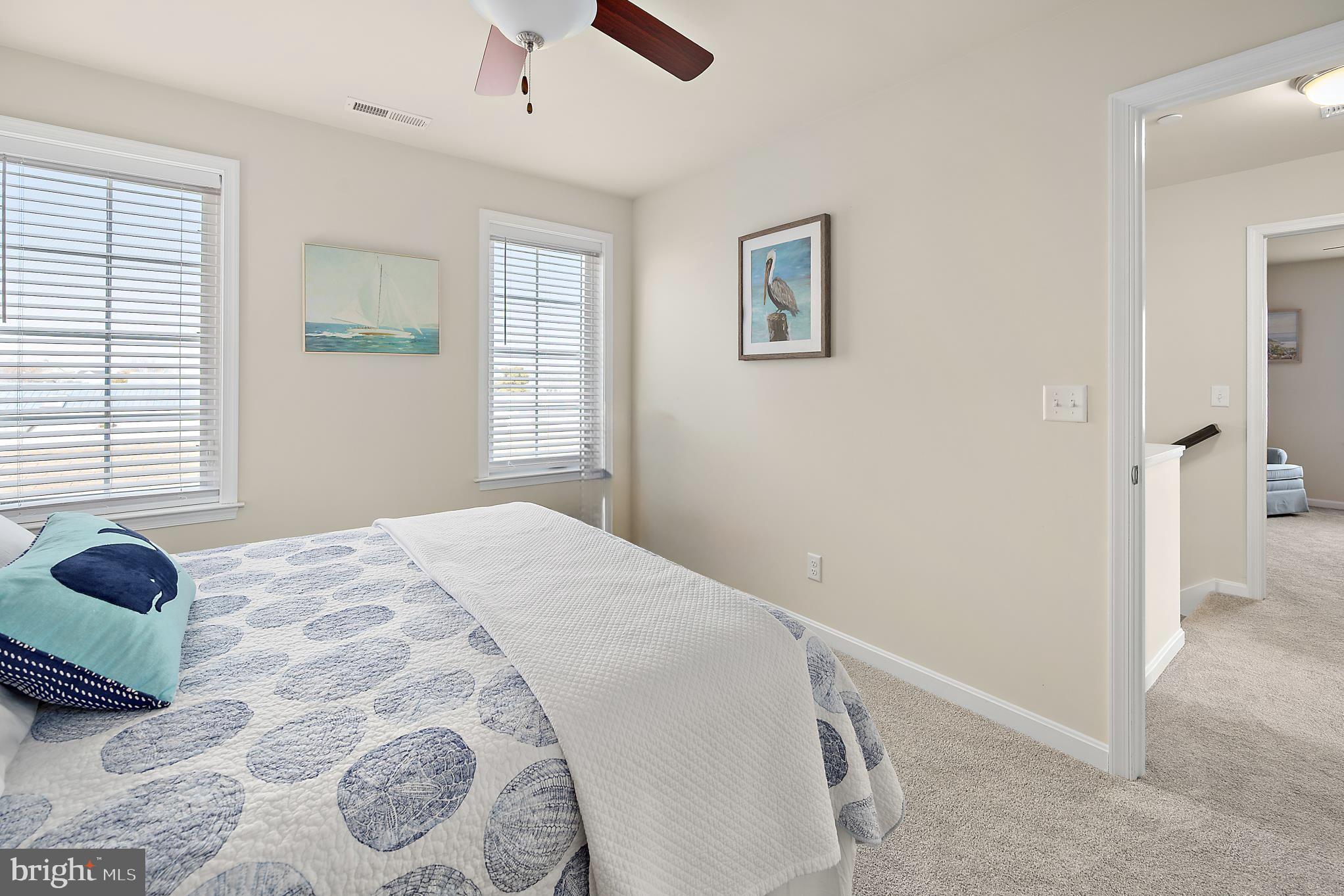 144 Clamshell Road Ocean City, MD 21842 - Photo 43 of 64 a bedroom with a bed and a window