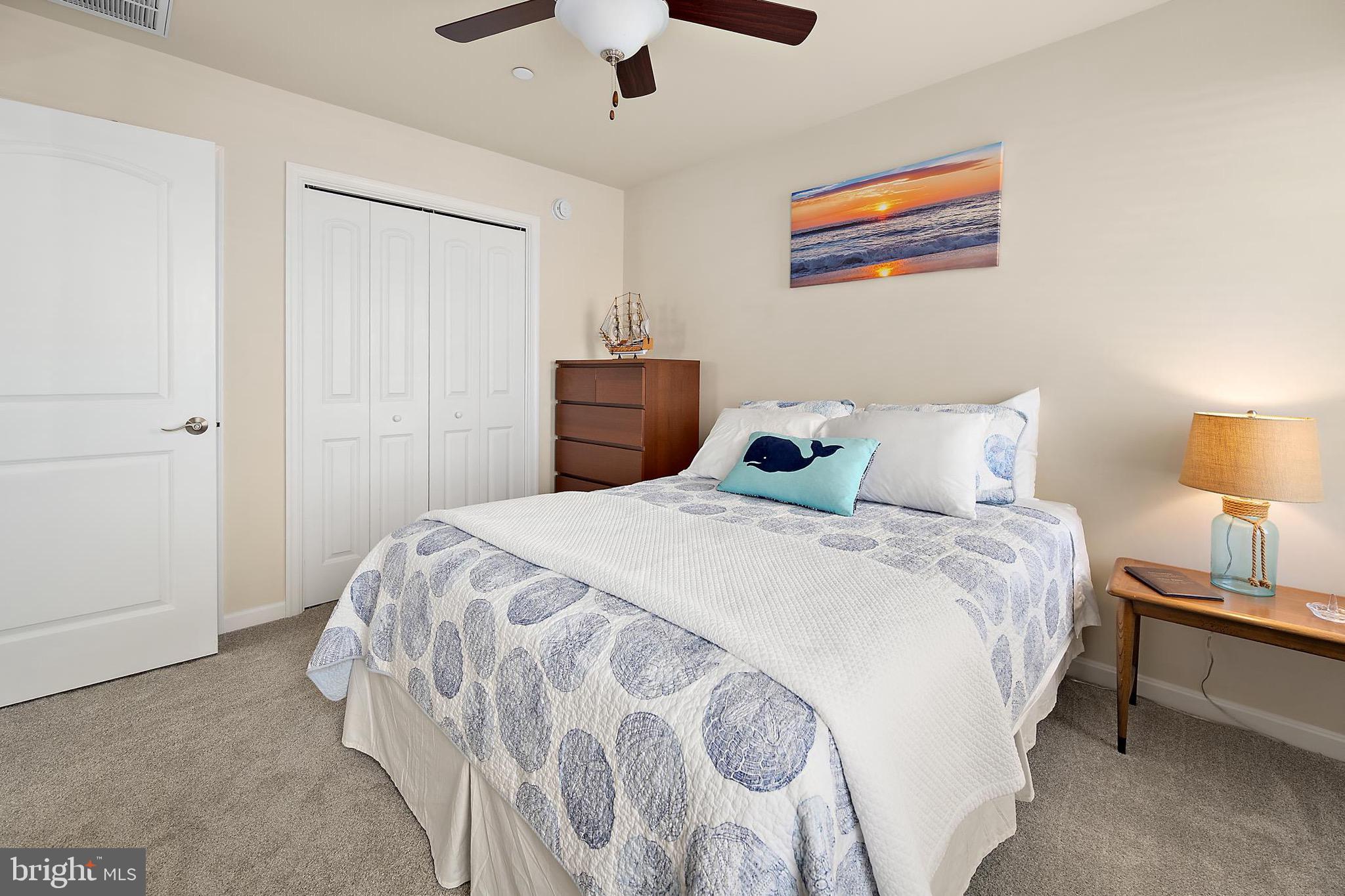 144 Clamshell Road Ocean City, MD 21842 - Photo 44 of 64 a bedroom with a bed and a lamp