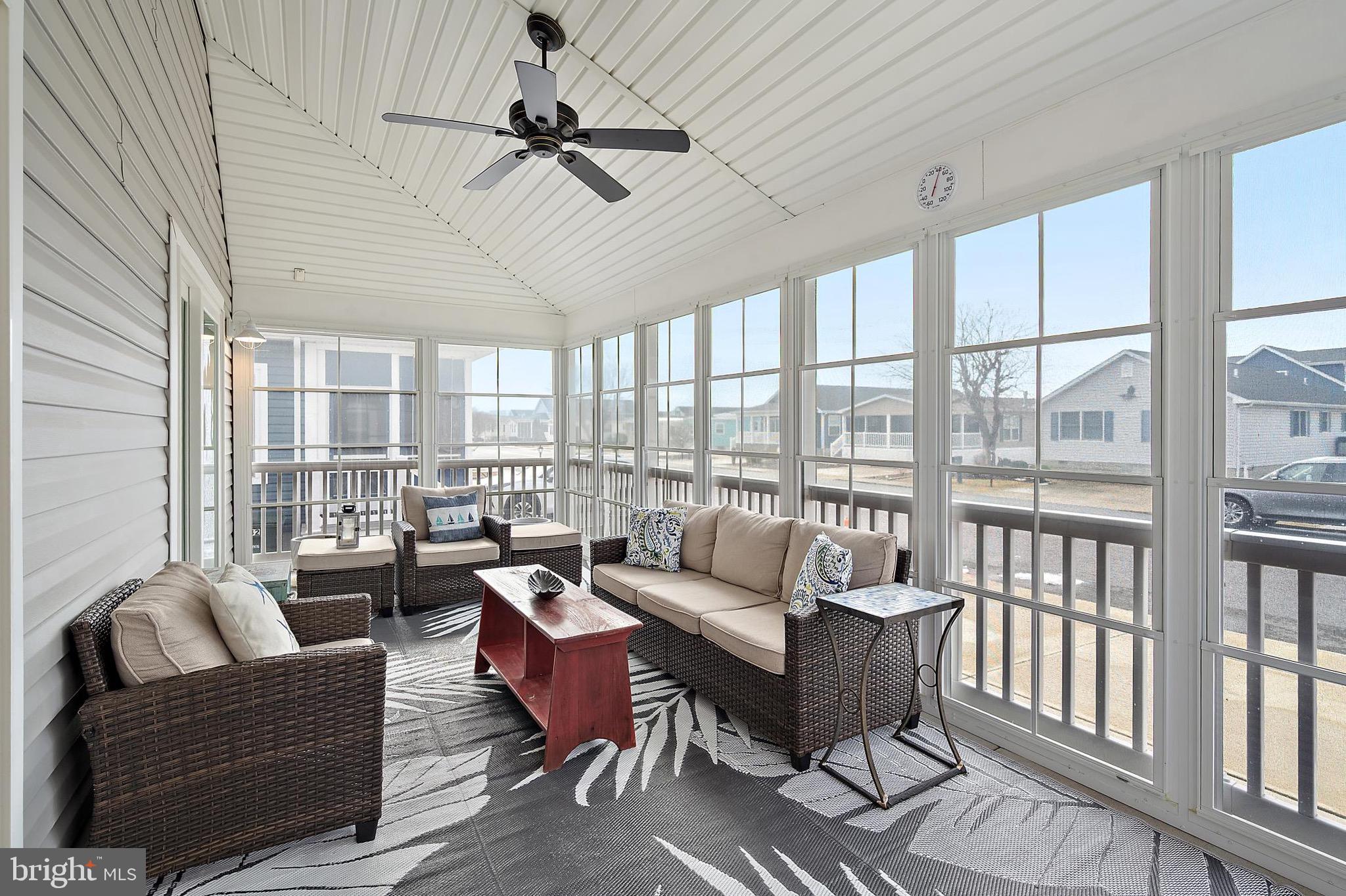 144 Clamshell Road Ocean City, MD 21842 - Photo 48 of 64 a living room with furniture and a large window